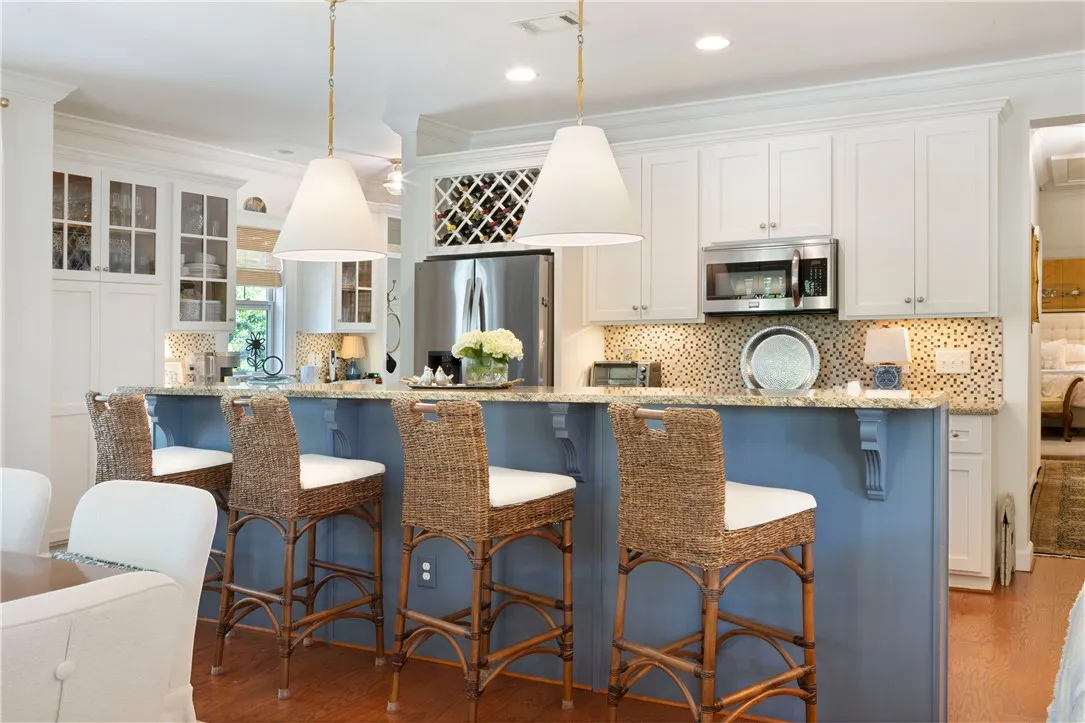 A well-lit kitchen with a spacious island for casual dining and entertaining.