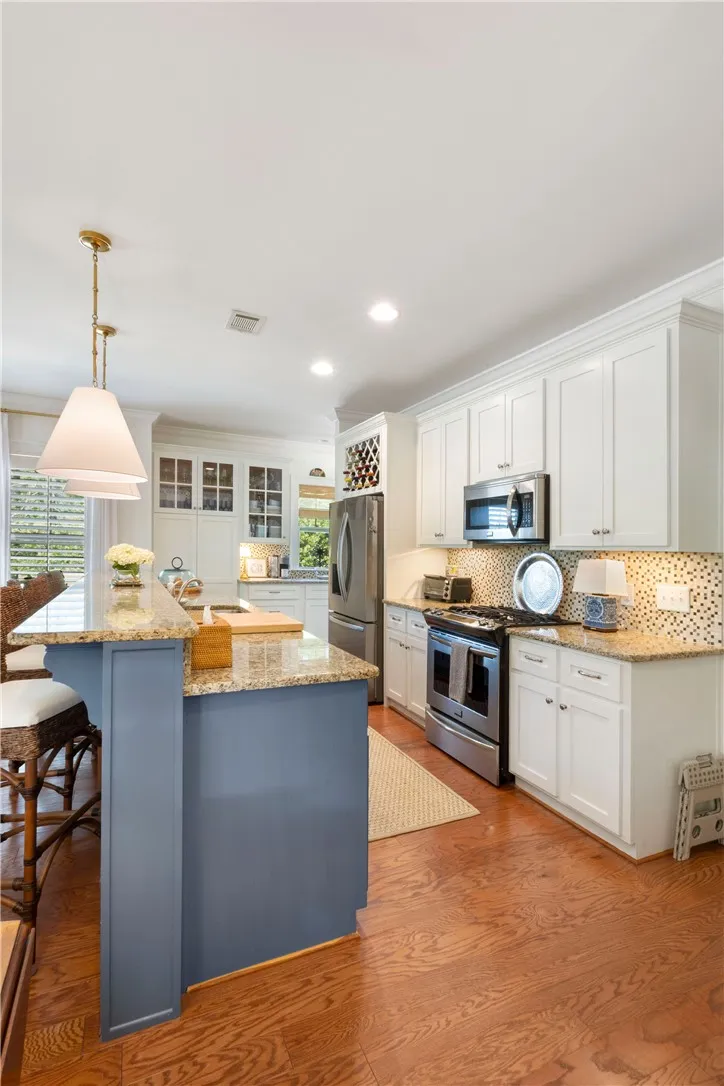 Culinary haven with granite counters, modern appliances, and a stylish island.