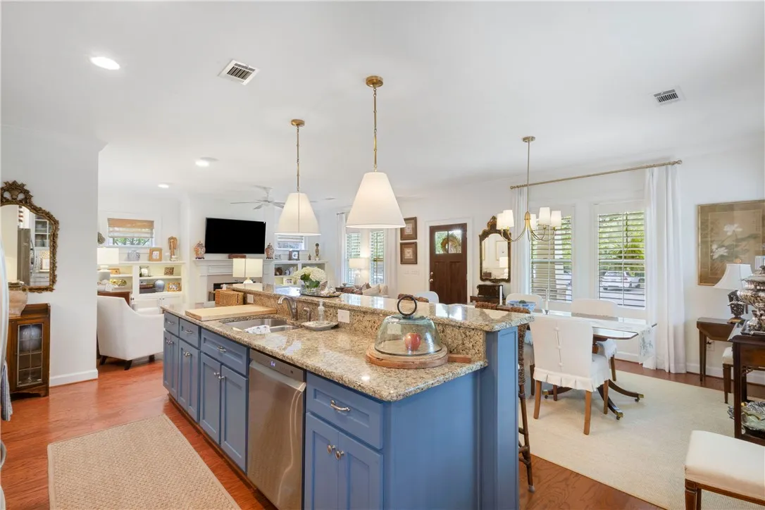 Granite counters and stainless appliances define this chef's kitchen, flowing into an inviting living area with a fireplace.