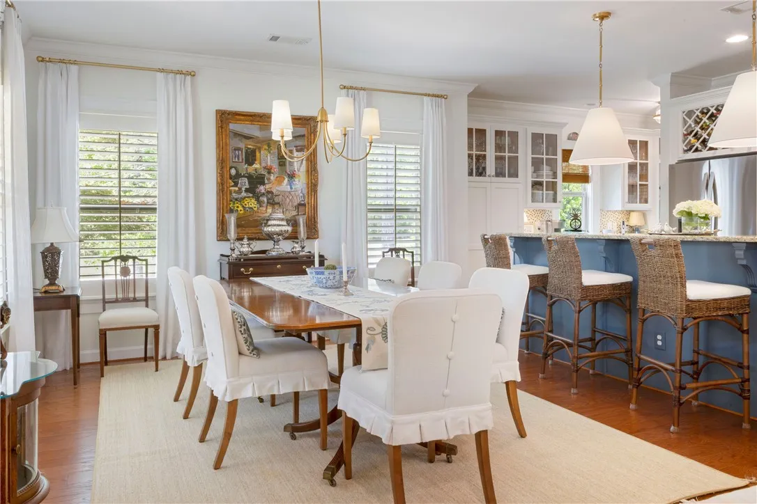An elegant dining space seamlessly transitions to a vibrant kitchen island, perfect for entertaining.