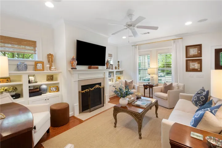 A refined living space features a cozy fireplace flanked by built-in shelving, perfect for intimate gatherings.