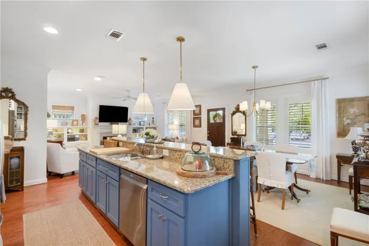 Granite counters and stainless appliances define this chef's kitchen, flowing into an inviting living area with a fireplace.