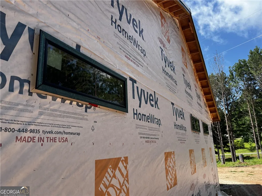 A glimpse into new construction, this home reveals its durable exterior sheathing and a long, horizontal window.