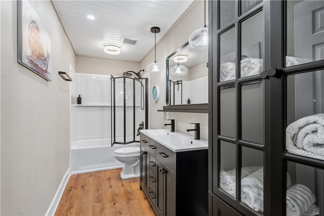 A well-appointed bathroom with a dual-sink vanity and a tub-shower combination.