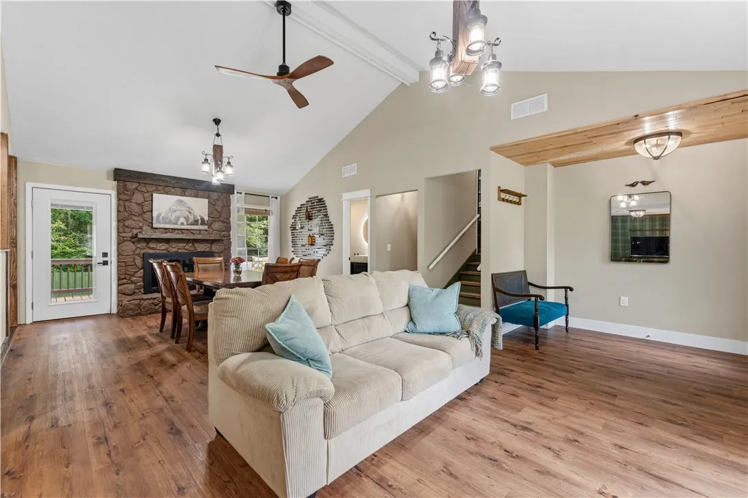 A spacious great room showcases high vaulted ceilings and beautiful wood flooring.