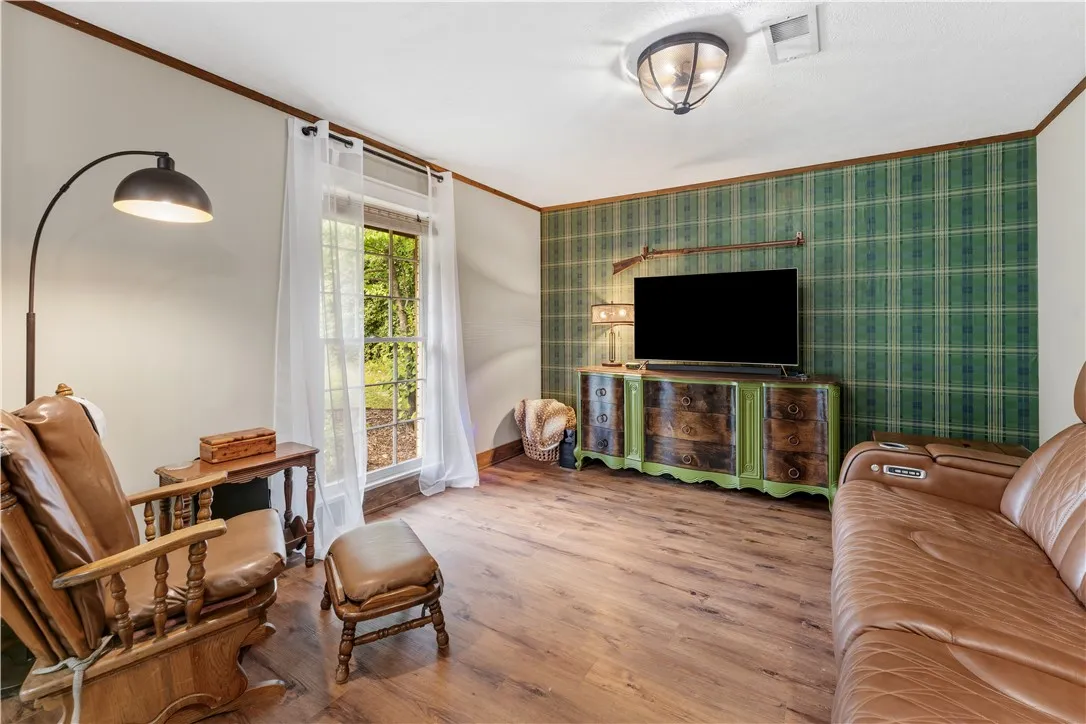 Wood flooring and plaid accent walls provide a unique, warm ambiance.