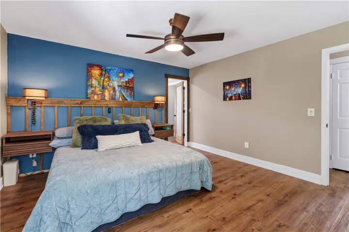 A comforting bedroom with warm wood floors, ready for quiet repose and relaxation.