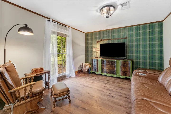 Wood flooring and plaid accent walls provide a unique, warm ambiance.