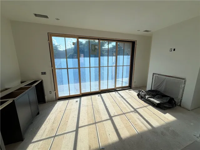 Sun-filled interior space with sliding doors leading to the outdoors.