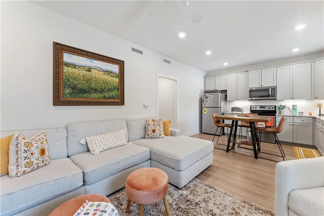 An inviting open-concept living space features a functional kitchen and comfortable lounge area.