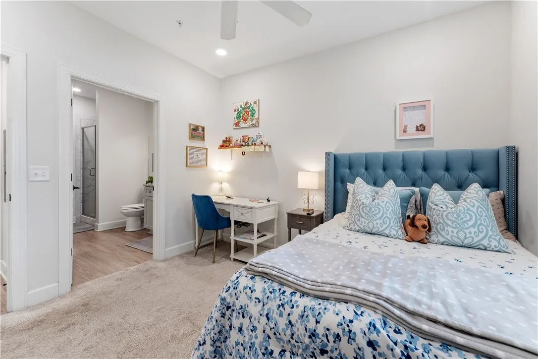 Well-lit sleeping quarters with a dedicated work area and private bath access.