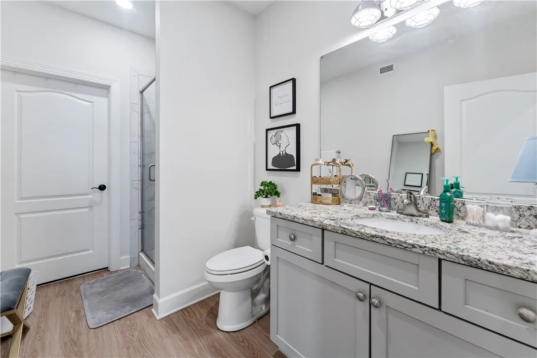 A well-appointed bathroom features a spacious vanity with ample storage and a contemporary shower.