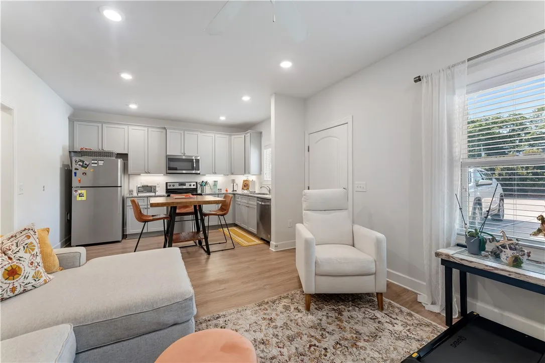 An open-concept living space integrates a well-appointed kitchen with comfortable seating areas.