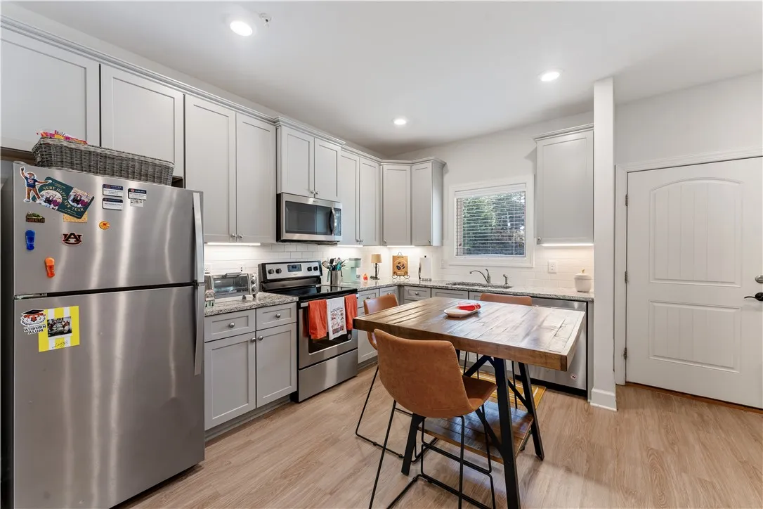 Granite counters, stainless steel appliances, and a window over the sink complete this well-appointed kitchen.