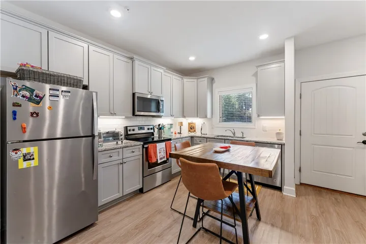 Granite counters, stainless steel appliances, and a window over the sink complete this well-appointed kitchen.