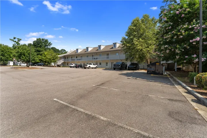 Ample asphalt parking accommodates residents of this multi-level residential building.