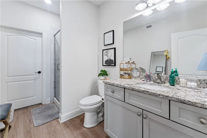 A well-appointed bathroom features a spacious vanity with ample storage and a contemporary shower.