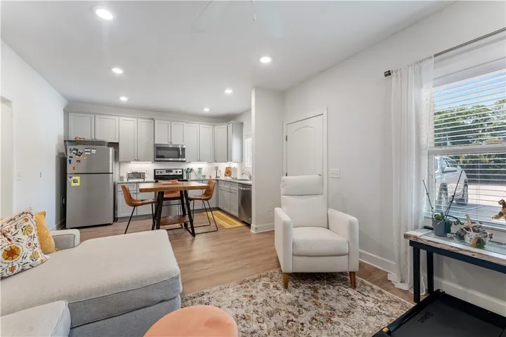 An open-concept living space integrates a well-appointed kitchen with comfortable seating areas.