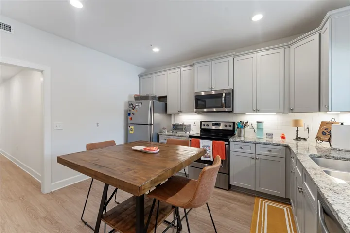 Culinary delights await in this modern kitchen with granite counters and stainless steel appliances.