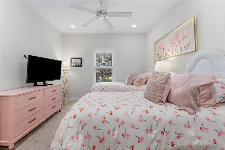 Two elegant beds with plush bedding and decorative pillows invite rest in this cozy sleeping space.