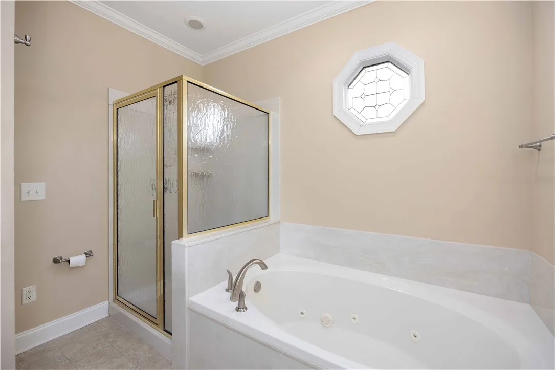 Unwind in the jetted soaking tub, complemented by a nearby glass-enclosed shower.