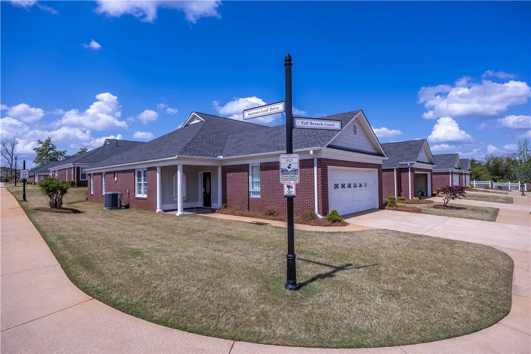 Rows of neatly maintained brick homes with attached garages await new residents.