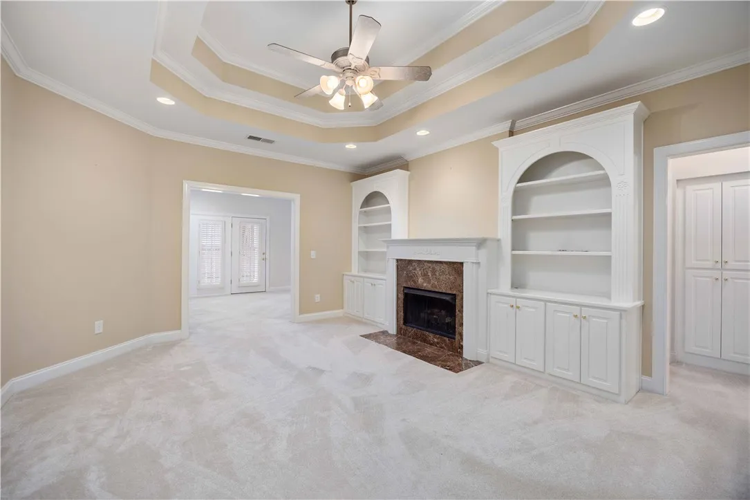 Elegant built-in shelving and a cozy fireplace anchor this inviting living space.