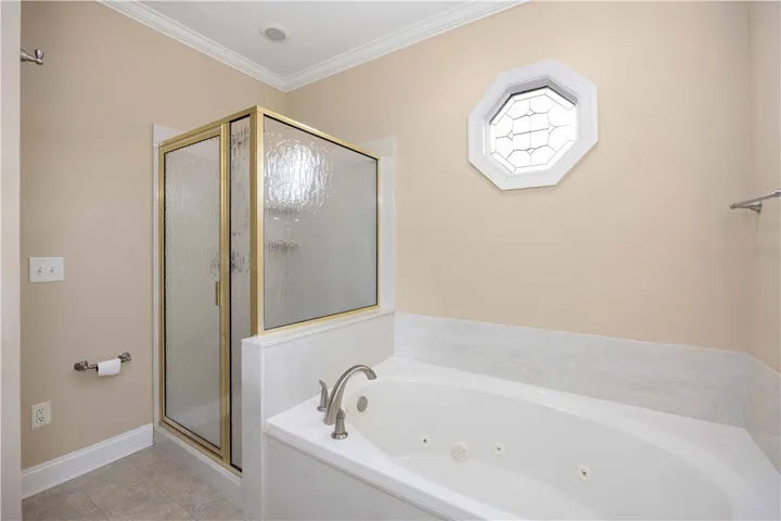Unwind in the jetted soaking tub, complemented by a nearby glass-enclosed shower.