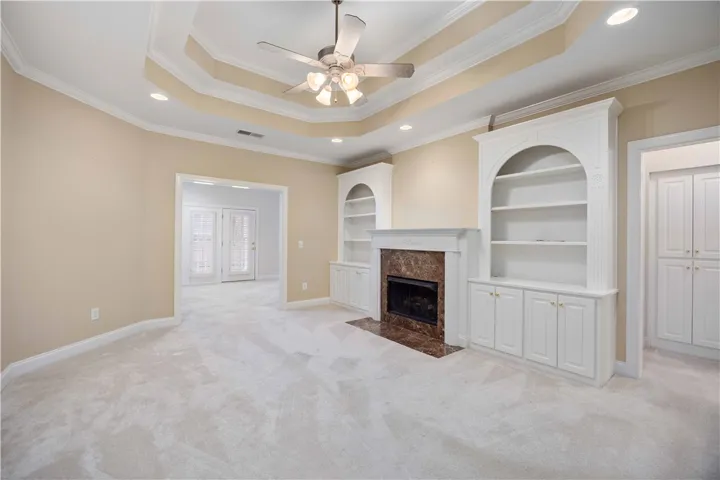 Elegant built-in shelving and a cozy fireplace anchor this inviting living space.