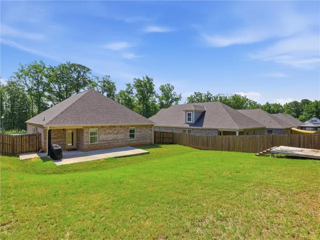 A spacious backyard with ample green space awaits, perfect for outdoor recreation and relaxation.