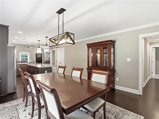 Rich hardwood floors complement this spacious dining area, perfect for entertaining.