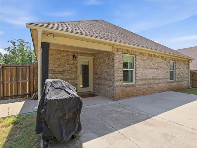 A private backyard patio extends from this charming brick residence.