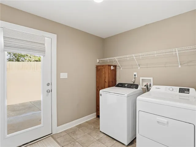 A dedicated laundry room with functional appliances and practical shelving for home organization.