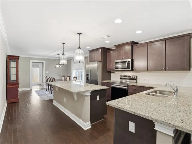 Granite counters and rich wood flooring elevate this chef's kitchen, perfect for entertaining.
