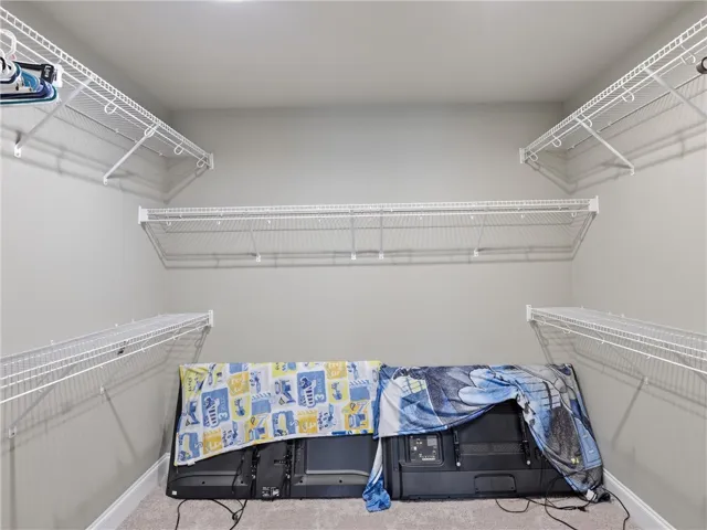 Customizable wire shelving in this well-appointed closet offers adaptable storage solutions.