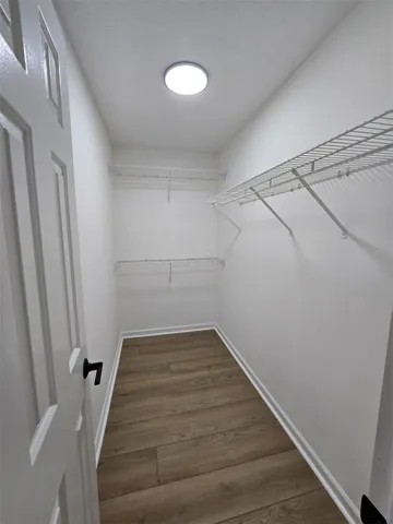 Ample storage solutions elevate this organized, well-lit closet space.