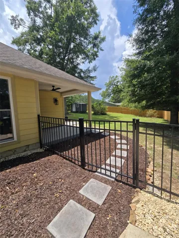 A private backyard oasis features a covered patio with direct access to a verdant lawn.