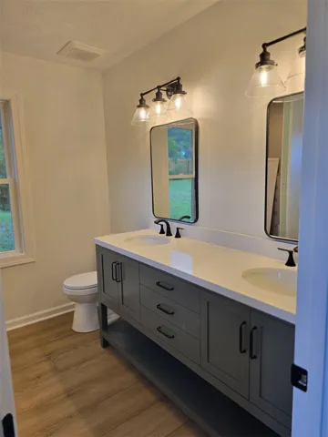 Modern double vanity with clean lines and dual mirrors offers both style and function in this bright bath.