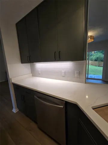 The well-appointed kitchen offers sleek cabinetry, ample counter space, and modern appliances.