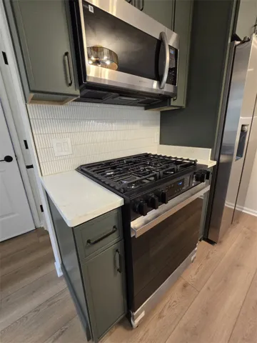 Culinary delights await in this modern kitchen with sleek appliances and practical design.