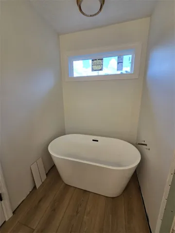 A deep soaking tub sits gracefully within a niche, offering a tranquil escape.