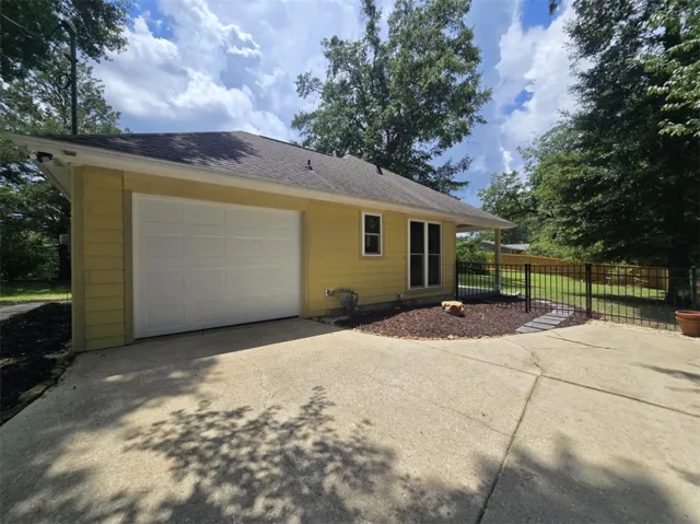 A well-maintained single-story home with an attached garage and practical driveway access.