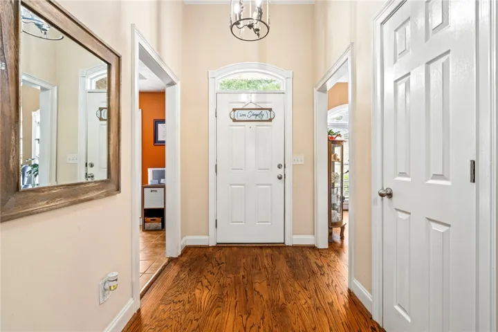 Rich hardwood floors welcome you into this inviting entry hall, setting a refined tone.