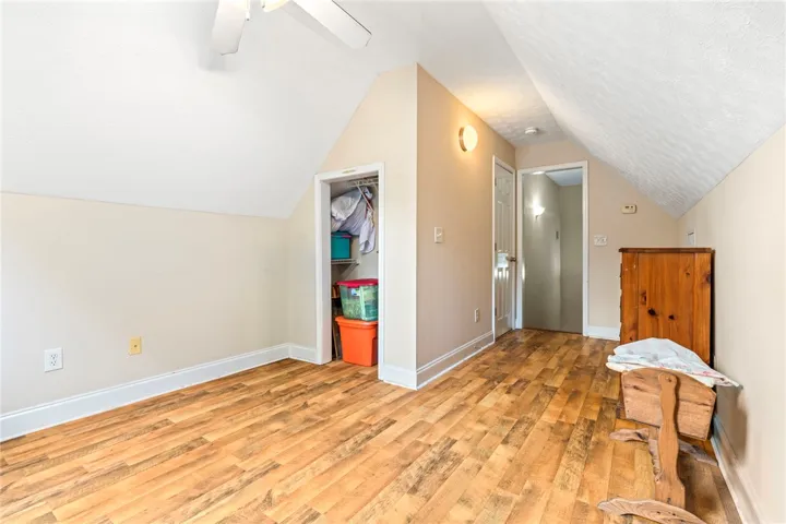 Slanted ceilings and warm wood flooring define this versatile attic space.