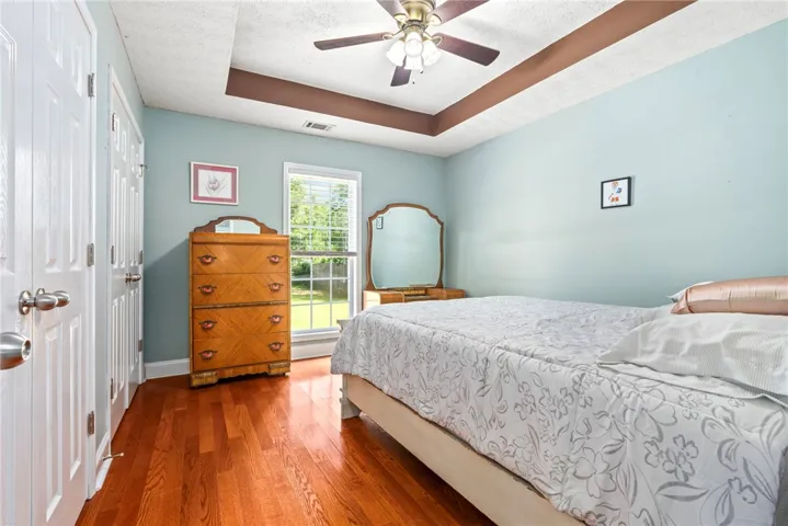 Hardwood flooring and tray ceilings create a comfortable and stylish personal retreat.