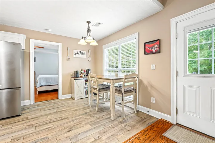 An inviting eat-in kitchen with a charming breakfast bar and natural light from the large window.
