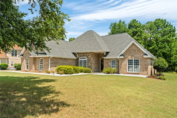 A classic brick exterior with stone accents welcomes you to this inviting residence.
