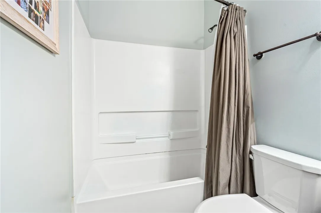 Functional bath with shower, a serene space for daily refreshing.