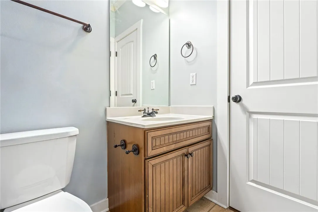 Functional full bathroom featuring a vanity with ample storage and a classic white toilet.