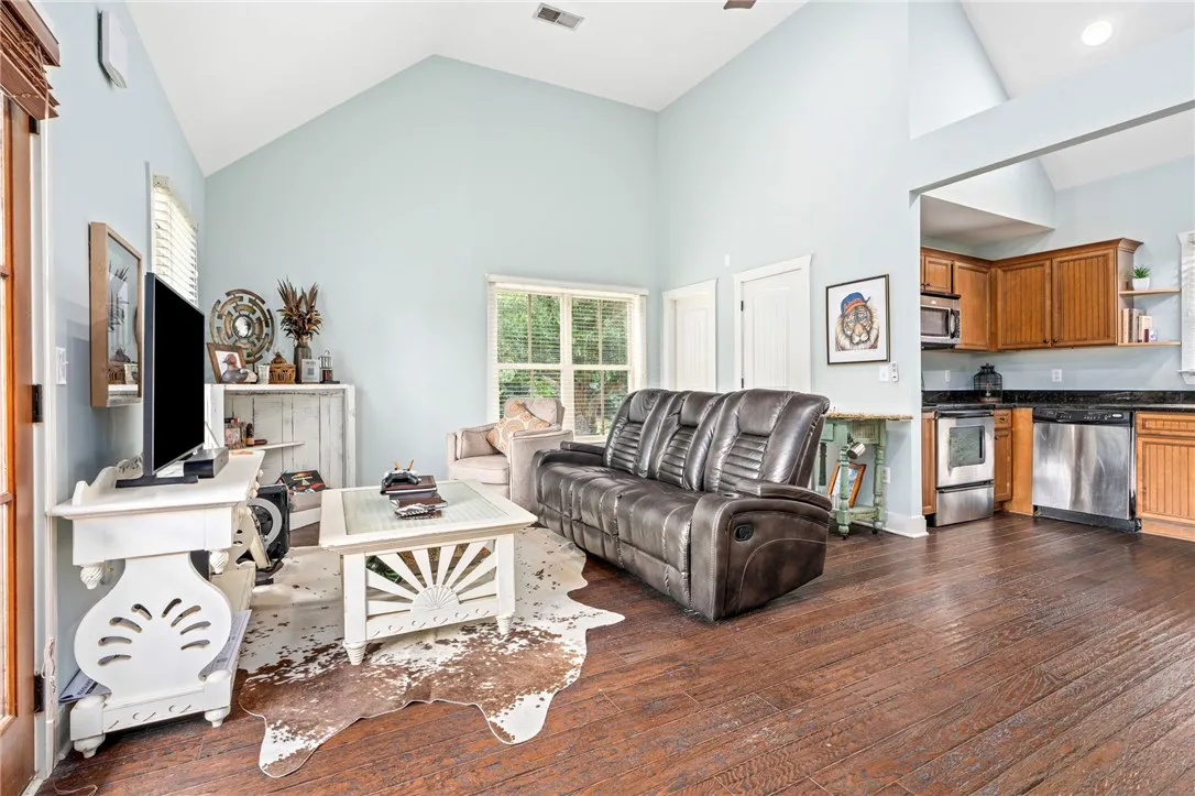A great room with soaring vaulted ceilings and richly stained hardwood floors.